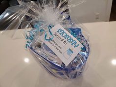 a basket with toothbrushes wrapped in plastic and sitting on a white counter top