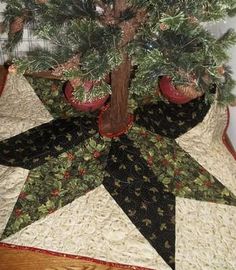 a quilted christmas tree skirt with pine cones on it