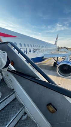 an airplane is parked at the airport with its door open