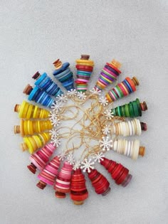 many different colored thread spools arranged in a circle