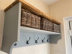 a shelf with hooks and baskets on it