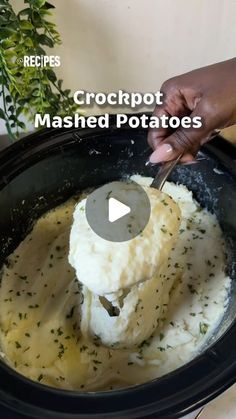 a person stirring mashed potatoes in a crockpot