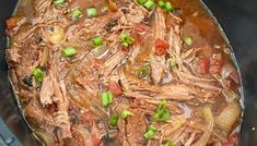 a pot filled with meat and vegetables on top of a stove