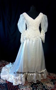 a white wedding dress on display in front of a black background with an ornate rug