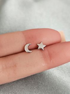 These minimalist sterling silver crescent moon and star earring studs will look great with any outfit. The sterling silver material is hypoallergenic so no worry about skin irritation or other allergies. Makes the perfect meaningful gift for any occasion - birthdays, holidays, or just because your special loved one deserves something special Size: approximately 6mm. Post size: 20gauge, 11mm long. Finish: platinum plated over solid sterling silver Sold as a pair Comes with gift box ready for gift Nickel-free Star-shaped Silver Piercings, Nickel Free Silver Star-shaped Piercing, Silver Crescent Earrings With Star Charm, Nickel-free Silver Star Piercings, Silver Star-shaped Cartilage Earrings With Pierced Design, Silver Star-shaped Pierced Cartilage Earrings, Silver Crescent Single Cartilage Earring, Silver Moon Shaped Cartilage Earrings, Minimalist Silver Star Piercings