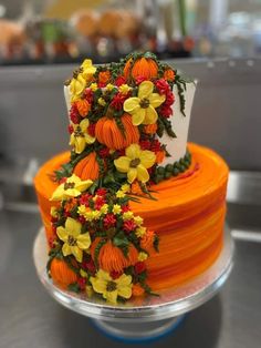 an orange and yellow cake with flowers on top