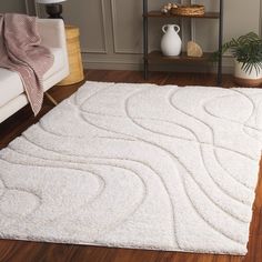 a white area rug with wavy lines on the top and bottom, in a living room