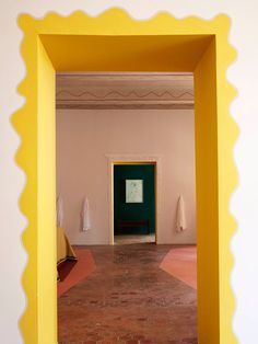 an empty room with yellow and green walls