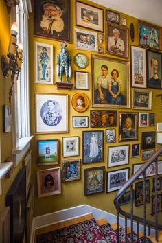 a staircase with many framed pictures on the wall