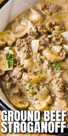 a close up of a bowl of food with meat and mushrooms in gravy