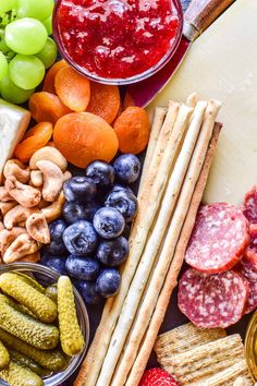 an assortment of fruits, crackers, and other foods