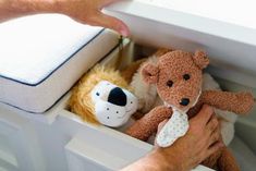 a person holding two stuffed animals in their hands