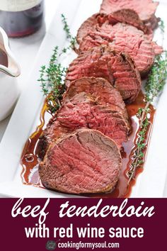 beef tenderloin with red wine sauce on a white platter