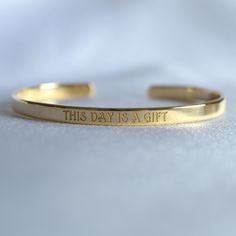 You can engrave this quote or any other text on our gold-plated timeless bracelet. - Narrow bracelet engraved with your chosen message. - The  thickness of gold plating is around 0.5 microns - Text, coordinates, numbers or handwriting outside and inside the cuff  - Up to 90 characters  on each side - Approximately 5mm wide, 16cm long This personalised gold plated bangle will make the perfect gift for mum, sister, grandma, bridesmaid or any other loved one in your life. SIZES: This is the length of the metal, not including the opening between the ends. The bracelets are adjustable. 4" (baby/toddler size) 5" (child size) 6.3" (standard - fits MOST adults) 7" (popular for men) With an elegant radiance to captivate the eyes, this gold-plated cuff will make you stand out from the crowd! Colors Engraved Name Bracelet For Personalized Gift, Yellow Gold Bracelet With Engraving Option, Inspirational Gold Bracelet Hand Stamped, Inspirational Gold Bracelet, Hand Stamped, Classic Etched Bracelets As Gift, Classic Etched Bracelets As A Gift, Inspirational Gold Name Bracelet For Personalized Gift, Inspirational Engraved Bangle Bracelets, Inspirational Hand Stamped Gold Bracelet