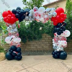 an arch made out of balloons in the shape of mickey mouses and minnie's feet