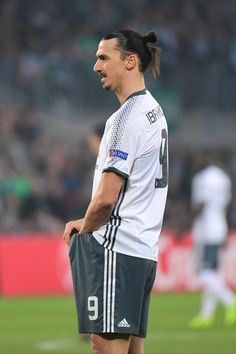 a man standing on top of a soccer field