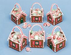 six christmas baskets with candy canes and candies in them on a blue background