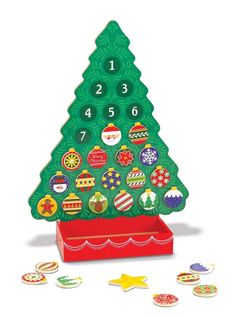 a wooden christmas tree with buttons and numbers on it's side, sitting in a red box