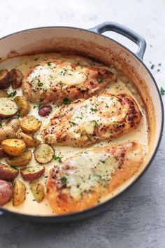 some chicken and potatoes are in a pan