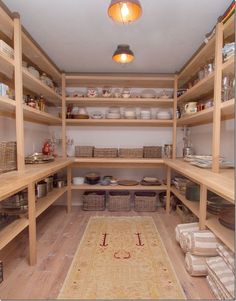 a kitchen with lots of wooden shelves and baskets