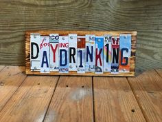 a wooden sign with the word dayddring spelled in multiple letters on it