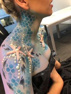 a woman with blue and white body art