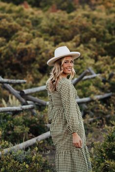 Looking for a unique dress for your fall family photos? Look no further than The Lila Gingham Dress in Olive! This cute midi dress features a flattering square neck and smocked bodice. Perfect for playful family photos! Paired with THE MIMI COWGIRL BOOTS IN WHITE Square neck Smocked bodice Elastic long sleeves Midi length Side pockets 100% cotton Model is 5'9" wearing a small. Fits true to size. Small (0-2), Medium (4-6), Large (8-10). Length (shoulder to hem): Small: 45.5”, Medium: 46.5”, Large Fruit Picking Outfit, Happy Threads, Summer Goddess, Pink Desert, Unique Dress, Fall Family Photos, Exclusive Clothing, Nursing Friendly, White Square