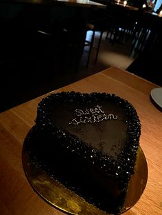 a heart shaped cake sitting on top of a wooden table