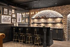 a bar with stools and pictures on the wall