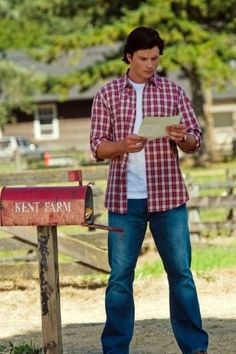 a man standing in front of a mailbox