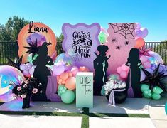 there are balloons and decorations on the table for an event or birthday party that is decorated with black silhouettes