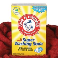 a box of arm and hammer super washing soda sitting on top of a red blanket