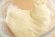 the dough has been made into a heart shape in the bowl with a whisk on top