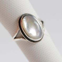 "All Sterling Silver items in our shop are stamped 925, lead and nickel free, solid 925 silver, NOT plated or filled. Mother of Pearl 925 Sterling Silver Handmade Ring Genuine Mother of Pearl with Rainbow reflection June Birthstone  Fast shipping from USA!  Exquisite craftsmanship!  Finest quality sterling silver 925.    Length: 5/8\" Width: 3/8\" Mother of Pearl is a June birthstone, and is considered by many to bring protection and calming effects to the wearer. Stamped .925 sterling silver. Sterling Silver Pearl Ring With Polished Finish, Hallmarked Sterling Silver Pearl Ring, Silver Sterling Silver Pearl Ring With Polished Finish, Oval Sterling Silver Pearl Ring, Fine Jewelry Sterling Silver Pearl Ring With Oval Shape, Classic Polished Moonstone Ring Gift, Silver Pearl Ring With Polished Finish In Fine Jewelry, Oval Sterling Silver Pearl Ring In Fine Jewelry Style, Fine Jewelry Oval Pearl Ring In Sterling Silver