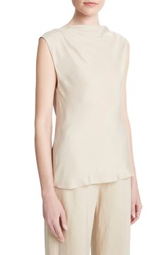 A gentle drape animates a silk-forward top that works as a low-profile first layer or a quietly luxe solo player. 23 1/2" length (size Medium) Boat neck Cap sleeves 55% silk, 45% rayon Dry clean or hand wash, line dry Imported Solo Player, Cap Sleeves Blouse, Draped Top, Silky Blouse, Cellulose Acetate, High Neckline, Hip Length, Boat Neck, Cap Sleeve