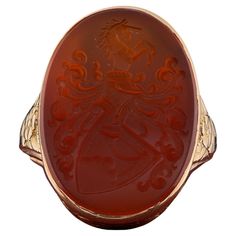 Victorian Signature Ring A Stunning Victorian period armorial ring, skillful hand crafted of solid 14 Kt gold Unique designed mount with flowers and leaf exalting the beauty of this ring Intricate coat of arms skillfully engraved on Carnelian stone rich and crisp details beautifully expressed in this past artwork Crown is 35 x 18 mm. h x w with 7.3 grams gross weight Fine condition keeping with age, sign of a previous re-sizing Sought after, beautiful example Unless otherwise stated boxes are for presentation only Further Details Below Metal: 14 Kt yellow gold Hallmarks: assay Gems: 1 oval carved carnelian of 23 x 17 mm. UK size: N 3/4 US size: 7 Measures: head is 25 x 18 mm. (h. x w.) Weight: 7.3 grams Signature Ring, Signature Rings, Victorian Period, Carnelian Stone, Signet Ring, Coat Of Arms, Jewelry Rings, D Art, Hand Crafted