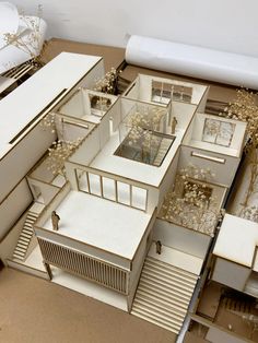 an aerial view of a model house with lots of windows and plants on the ground