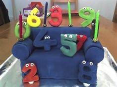 a birthday cake that is shaped to look like a couch and has eyes on it