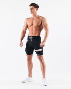 HIGHLIGHTS.. Unlined boardshort. 9” inseam Reflective branding at leg opening and back waistband Elastic waistband with adjustable self-tie drawcords Color-blocking panelling Water resistant fabric FIT SUGGESTION. This item runs true to Alphalete’s standard sizing.. Fit is based off of waist size in inches.. If you are between sizes, we recommend sizing up for a relaxed fit.. Eric is 6’2”/188cm, wearing a size 32. MATERIALS AND WASHING DIRECTIONS. 67% Nylon, 23% spandex. Due to the high saturati Athleisure Athletic Shorts For Water Sports With Built-in Shorts, Athleisure Athletic Shorts With Built-in Shorts For Water Sports, Sporty Black Swimwear With Built-in Shorts, Summer Training Activewear With Drawstring, Training Shorts With Drawstring, Training Athletic Shorts With Functional Drawstring, Sporty Fitted Shorts With Functional Drawstring, Black Swimwear With Functional Drawstring And Short Shape, Functional Drawstring Athletic Shorts For Training