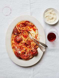 a white plate topped with spaghetti and sauce