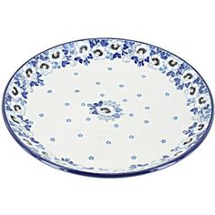 a blue and white bowl with flowers on the rim is shown in front of a white background