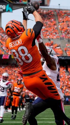 a football player catching a ball in the air