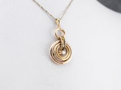 This diamond pendant is unique and eye-catching! Concentric hoops of 14 karat gold shine with contrasting textures, creating a lovely play of light. The diamond is set high in a buttercup setting that adds the perfect touch of femininity! This pendant does not come with the chain shown. Please feel free to contact us, we will help you find the perfect chain for your style and budget! Metal: 14K Yellow Gold Gem: Diamond .08 Carats, VVS in Clarity, F in Color Gem Measurements: 2.7 mm, Round Measur Luxury Square Pendant Jewelry With Diamond Accents, Collectible Gold Square Pendant Jewelry, 14k Gold Square Pendant With Diamond Accents, Fine Jewelry Hallmarked Square Pendant, Gold-plated Yellow Gold Square Pendant Jewelry, Contrasting Textures, Colored Gems, July Birthstone, Diamond Gold