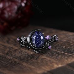 Oval cut Blue Sandstone engagement ring set unique Moon style amethyst cluster ring gothic black gold rings for women leaf branch rings -----Ring Information----- ✦Engagement Ring Metal Type: 925 sterling silver, 10K/14K/18K Solid Gold, Platinum Center stone: Blue sandstone Stone size: 6x8mm oval cut Side stone: amethyst ✦Wedding Band Stone: Round amethyst  ✦ Please feel free to contact me if you have any questions or you are interested in custom order. ✦Black rhodium plating: Rhodium, a valuabl Elegant Crescent Rose Cut Diamond Jewelry, Crescent Rose Cut Diamond Jewelry Gift, Crescent Shaped Rose Cut Diamond Jewelry Gift, Elegant Metal Rings With Gemstones, Fine Jewelry Crescent Gemstone, Fine Jewelry Crescent Gemstone Piece, Elegant Black Amethyst Gemstone Ring, Black Sapphire Fine Jewelry, Fine Jewelry Sapphire Jewelry In Purple