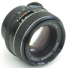 a camera lens sitting on top of a white surface