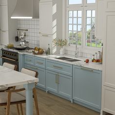 a kitchen with blue cabinets and white counter tops