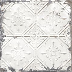 an old white tin ceiling tile with fleur de lis on the top and bottom