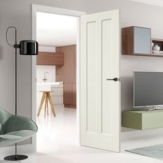 an open door leading to a living room with a tv on the wall and a green chair