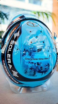 a close up of a helmet on display in a store window with the words crazy how time flies printed on it