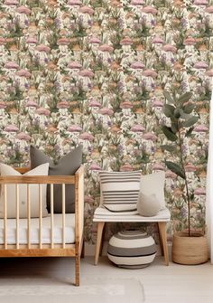 a baby's crib in front of a wallpaper with flowers on it